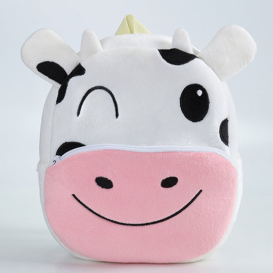 Child wearing cow backpack, playful and practical bag ideal for nursery, travel, and everyday adventures